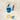 Clear pouch with blue and yellow bath toys on a white background