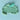 Blue play dough with embossed dinosaur motifs, shown with a matching mint green cylindrical chisel tool on a light blue background.