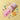 A pink pouch labeled 'WONDER DOUGH MIX' lies on a pale yellow background with spilled pink powder, colorful dough-like shapes, and a yellow bee-shaped cookie cutter.