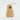 A wooden musical shaker shaped like a pear on a white background