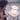 Child holding a teddy bear next to a glowing white bear-shaped night light on a small stool.