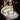 Assorted small desserts in a bowl with blurred chocolate background