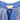 Close-up of a blue garment with a Meri Meri label and tulle details.