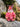 Pink owl plush toy with a unique design on a rock with natural background