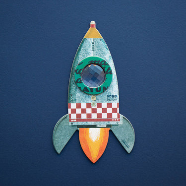 A rocket shaped compound kaleidoscope on a blue background