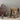 Miniature diorama with a house, characters, and a Christmas tree on a neutral background