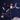 Fairy doll with a star wand against a dark blue night sky with stars and moon.