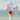 Person holding a seashell shaped inflatable pool float on a beach