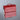 Red storage box with handles on a gray background