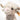 Close-up of a fluffy toy highland cow with a visible brand tag on a white background