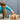 A little boy building a crab using the Kapla Wooden Building Planks 200 Natural Set against a blue wall