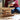 Child playing with Kapla wooden blocks, building a structure.