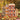 Structures made using the Kapla Wooden Building Planks 200 Autumn Set Box, set amongst autumn leaves.