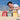 A child building beach boxes on the beach using the Kapla Wooden Building Planks in the Summer Box Set colour way.