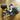 Two children playing with colorful stuffed toys on a wooden floor.