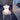 White bear-shaped lamp on a wooden stool in a room with a child in the background.