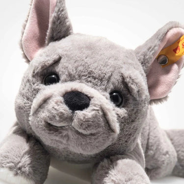 Plush toy bulldog with a visible brand tag on a white background