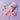 A pink pouch labeled 'WONDER POWDER MIX' lies on a lavender background with spilled pink powder, pastel candy-like pieces, and a pink unicorn-shaped cookie cutter or mold.