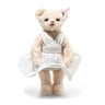 A Steiff teddy bear representing Marilyn Monroe wearing a white pleated dress on a white background