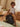 Child sitting on a space-themed ball in a cozy room with a couch and curtains.