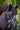 Close-up of a hobby horse head with a bridle in a natural setting