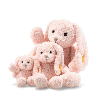 Steiff pink plush bunnies sitting on a white background