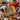 A box of glass marbles in a busy playroom with dolls and wooden toys 