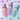 Three stand-up pouches of Magic Powder Cosmetics Wonder Poudré Mix are arranged on a pastel surface, with pink, purple and blue powder spilled below each pouch. Decorative squiggle shapes are placed around the scene.