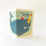 A greeting card with a whimsical whale illustration and the text 'Have a whale of a time!' on a clean white background.