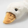 Close-up of a plush duck rattle with a white body and brown beak on a light gray background.