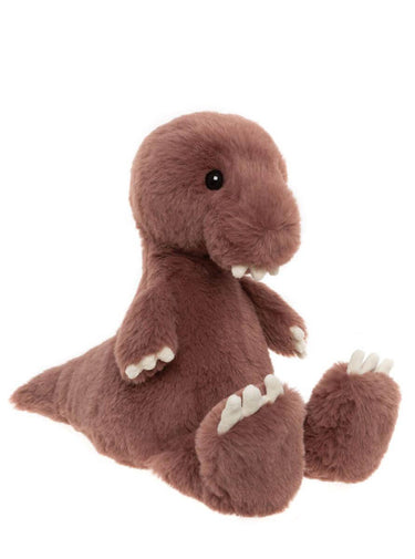 A browny pink plush dinosaur toy with white claws and teeth, sitting against a plain white background.