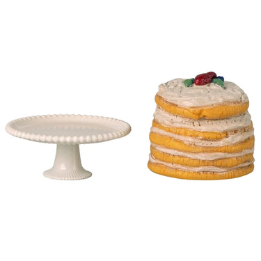Toy cake and cake stand on a white background