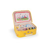 Yellow toy suitcase with a tea set inside on a white background