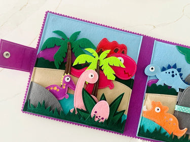 Children's felt dinosaur book with colorful felt figures on a white background