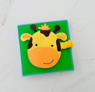 Children's book with a giraffe design on a green background