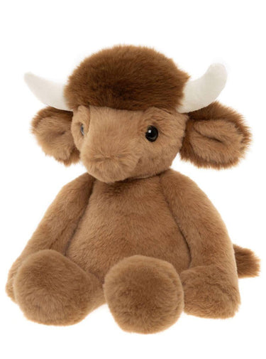 A plush toy highland cow with brown fur, a darker brown mane, white horns, and a black eye, shown against a plain white background.