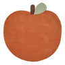 A stylized Ferm Living orange-brown apple rug with a small dark brown stem and a muted sage green leaf, shown on a plain white background.
