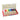 Kitpas crayon wax set in an open red box, showing multiple colored wax crayons in a row with a color chart printed inside the lid, on a white background.