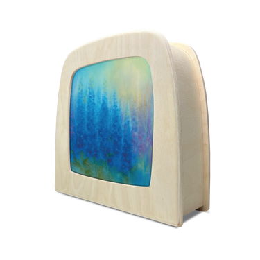 A table lamp with a colorful abstract forest painting in shades of blue, green, and purple, set against a plain white background.