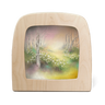 A square wooden picture frame with a rounded top, showcasing a pastel landscape painting of a snowy woodland path with white flowers and birch trees.