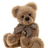 Brown teddy bear with a checkered bow tie on a white background