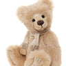Beige teddy bear with a scarf on a white background