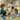 Children playing with 3D cardboard dinosaurs in a grassy park