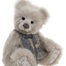 A gray and sparkling furred teddy bear wearing a grey patterned scarf on a white background
