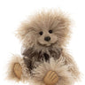 Fluffy teddy bear with a brown bow on a neutral background