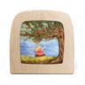 Wooden Toverlux lamp with a silhouette scene of a girl on a swing under a tree.