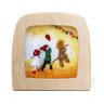 Wooden Toverlux lamp with a colorful illustration of three children at a dress up party on a yellow background.