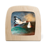 Wooden Toverelux lamp with a painted scene of a stork delivering a baby, flying over water on a white background