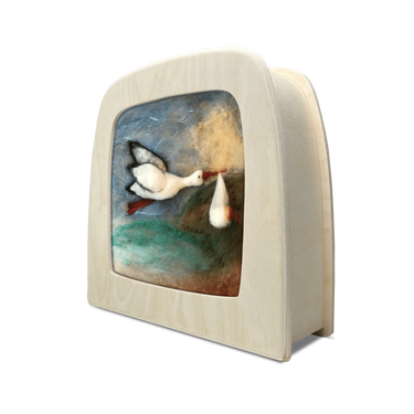 Toverlux lamp with a scene of a stork carrying a baby over the ocean, ready for delivery