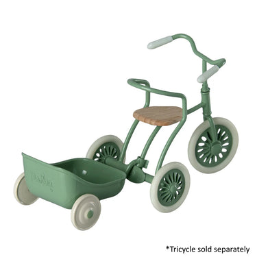 Green tricycle with a seat and wheels on a white background